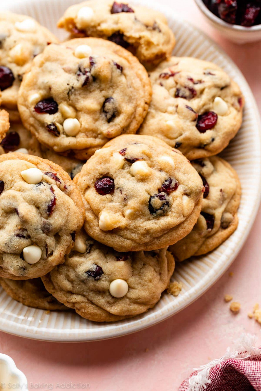 A plate of white chocolate chip cookies with cranberries.