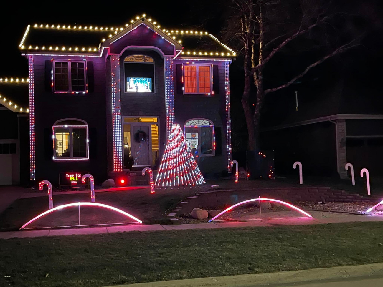 2-story home with Christmas lights, synced to music