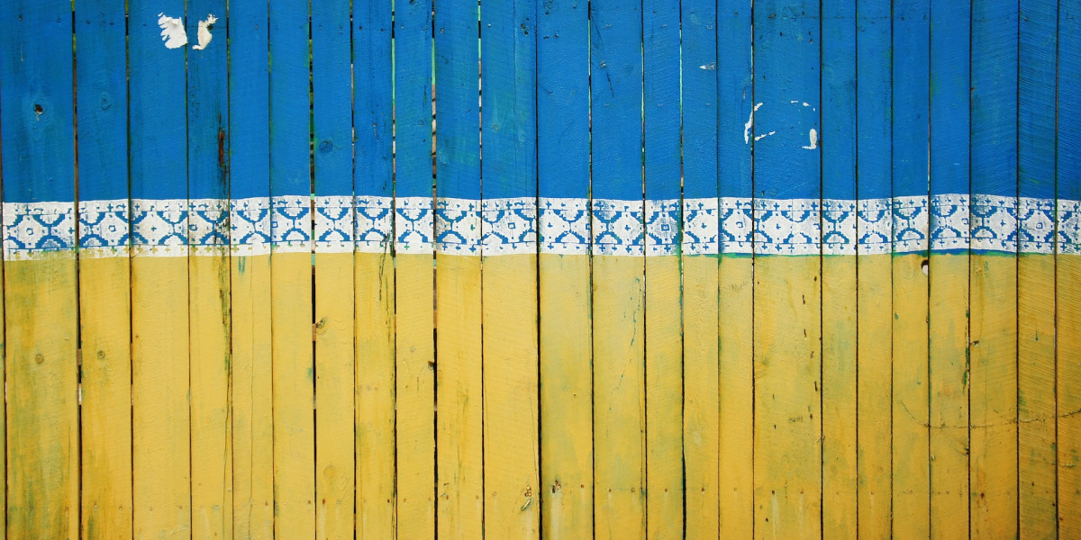 Fence painted in the colors of the Ukraine flag.