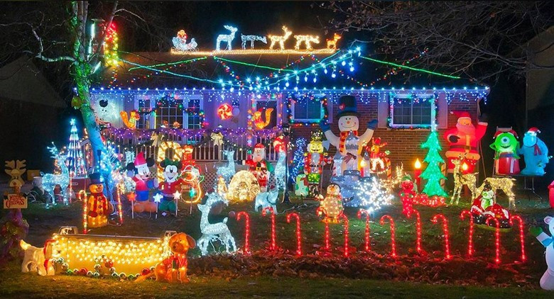 Picture depicting many christmas characters in front of a house.