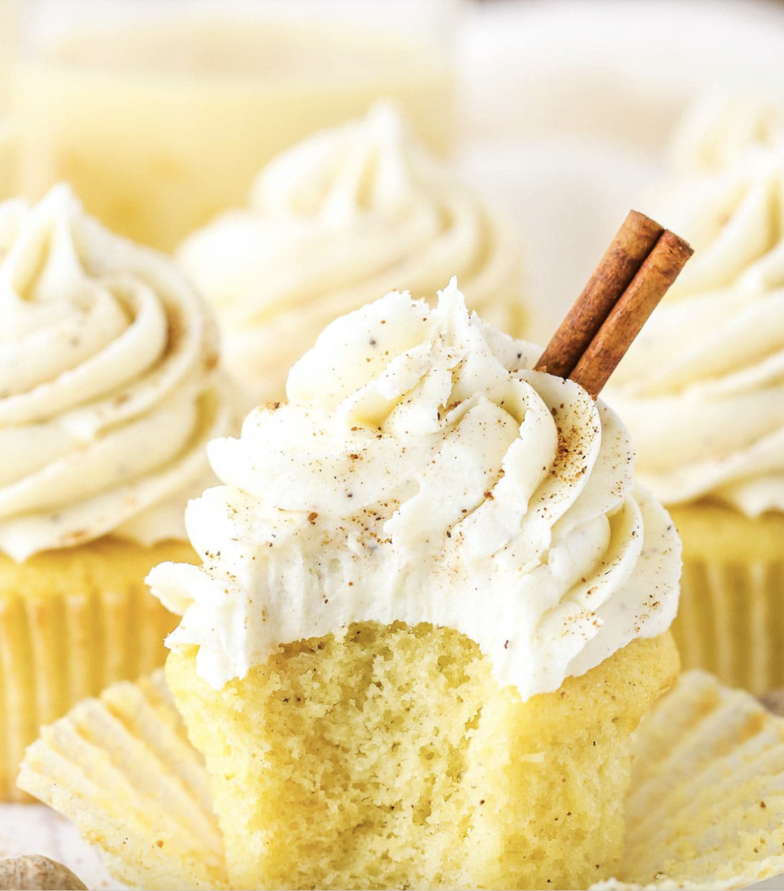 Vanilla cupcake, with white icing and a cinnamon stick as garnish.