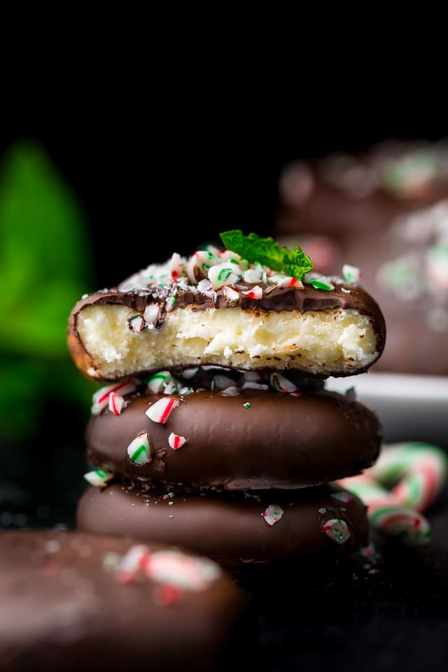a stack of 3 chocolate - covered cookies.
