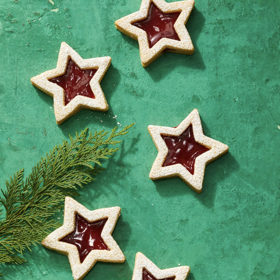 Sugar cookies in the shape of a star, jam inside.