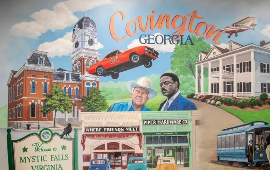 a mural of covington, Ga. depicting famous movies that have been filmed there.
